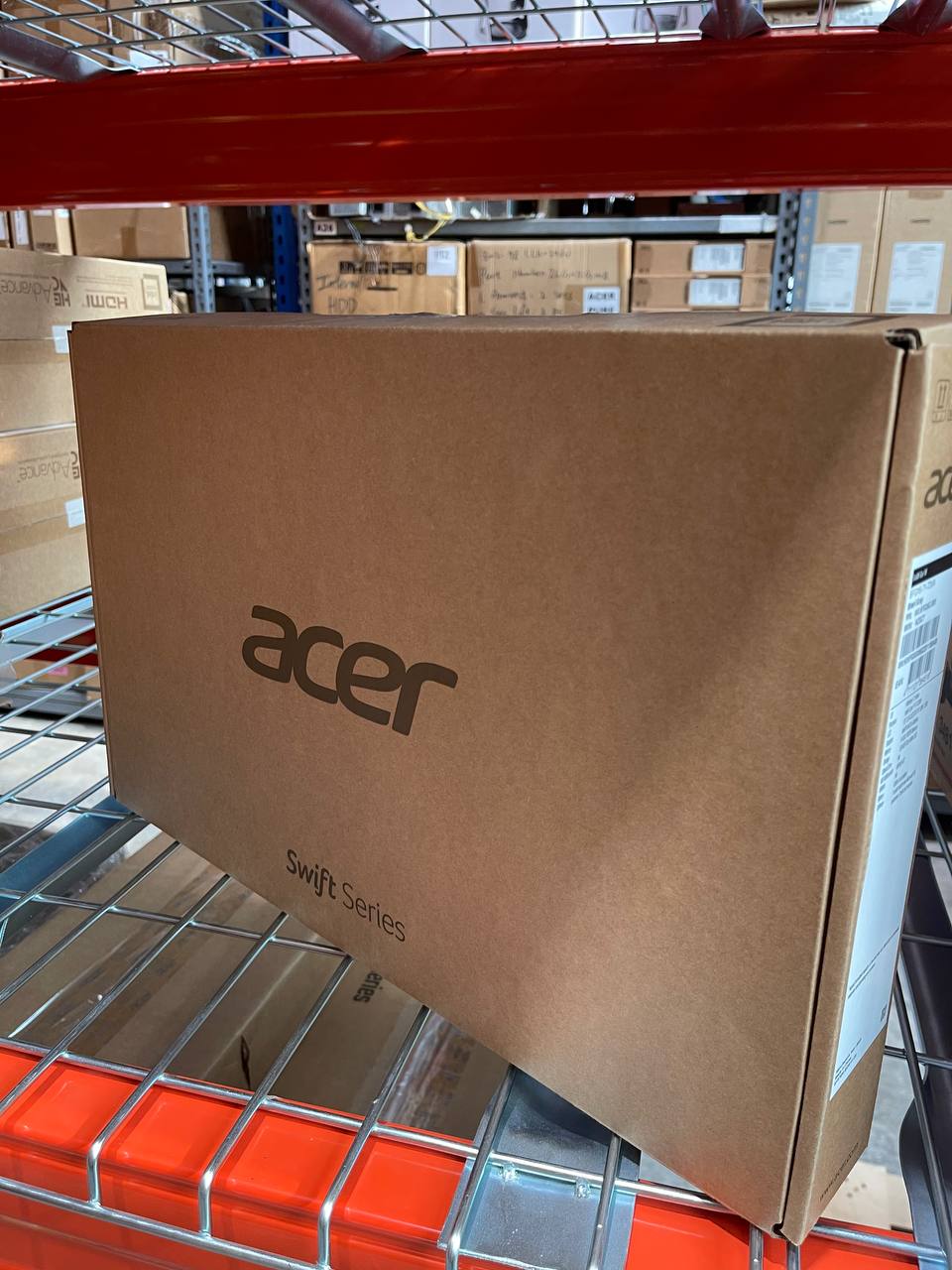 A sealed Acer Swift box on a shelf in our store room, with more boxes behind it